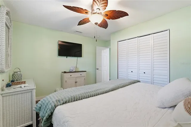 a bedroom with two beds and a chandelier