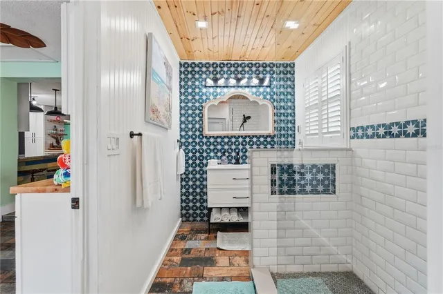 a bathroom with a sink toilet and mirror
