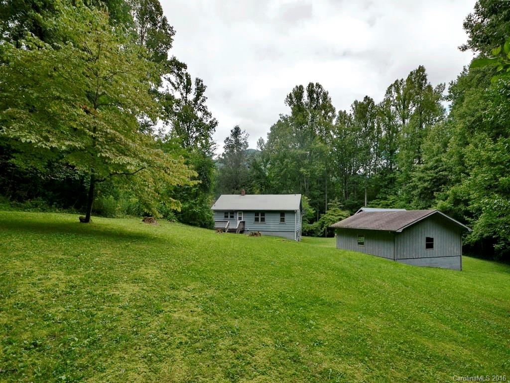 273 Pot Leg Road Waynesville, NC 28785 - Photo 3 of 12 a view of a house with a backyard and a patio