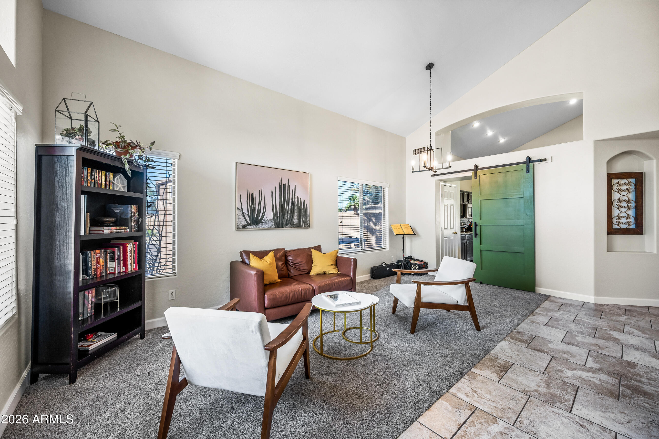 12734 West Cheery Lynn Road Avondale, AZ 85392 - Photo 12 of 54 a living room with furniture a rug and a book shelf