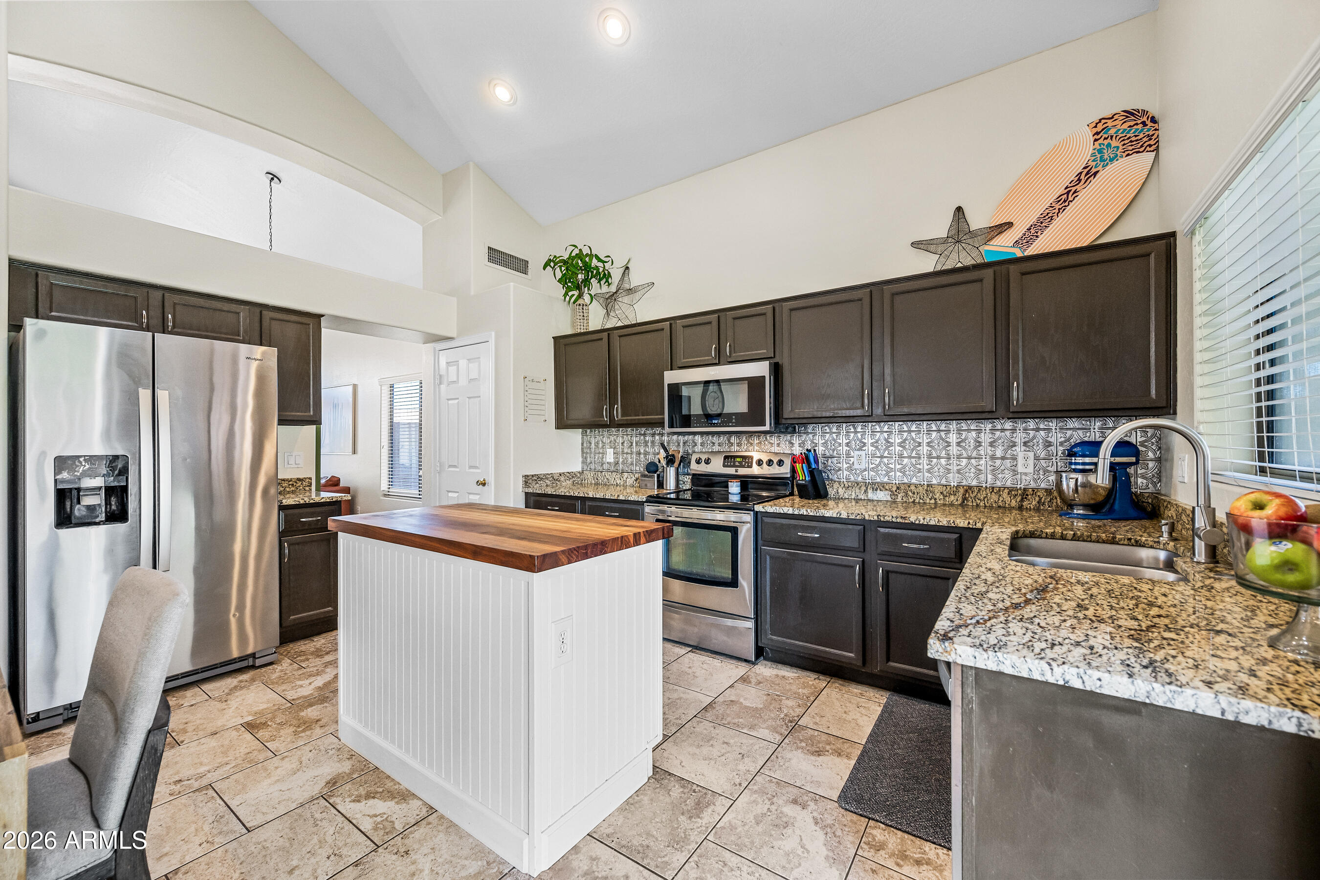 12734 West Cheery Lynn Road Avondale, AZ 85392 - Photo 19 of 54 a kitchen with stainless steel appliances granite countertop a stove top oven a sink dishwasher a refrigerator and a stove