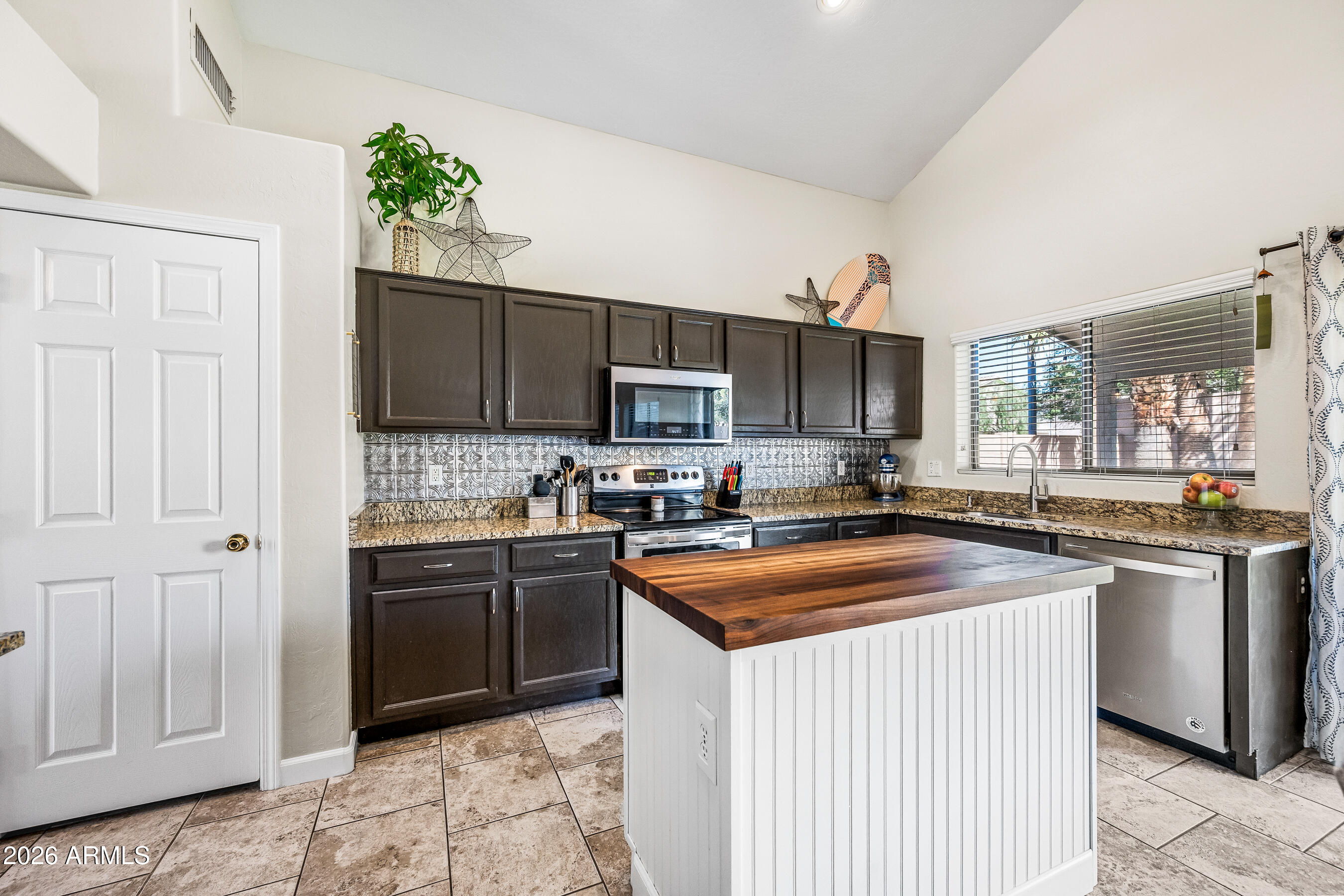 12734 West Cheery Lynn Road Avondale, AZ 85392 - Photo 22 of 54 a kitchen with stainless steel appliances granite countertop a stove a sink dishwasher a refrigerator and a microwave oven