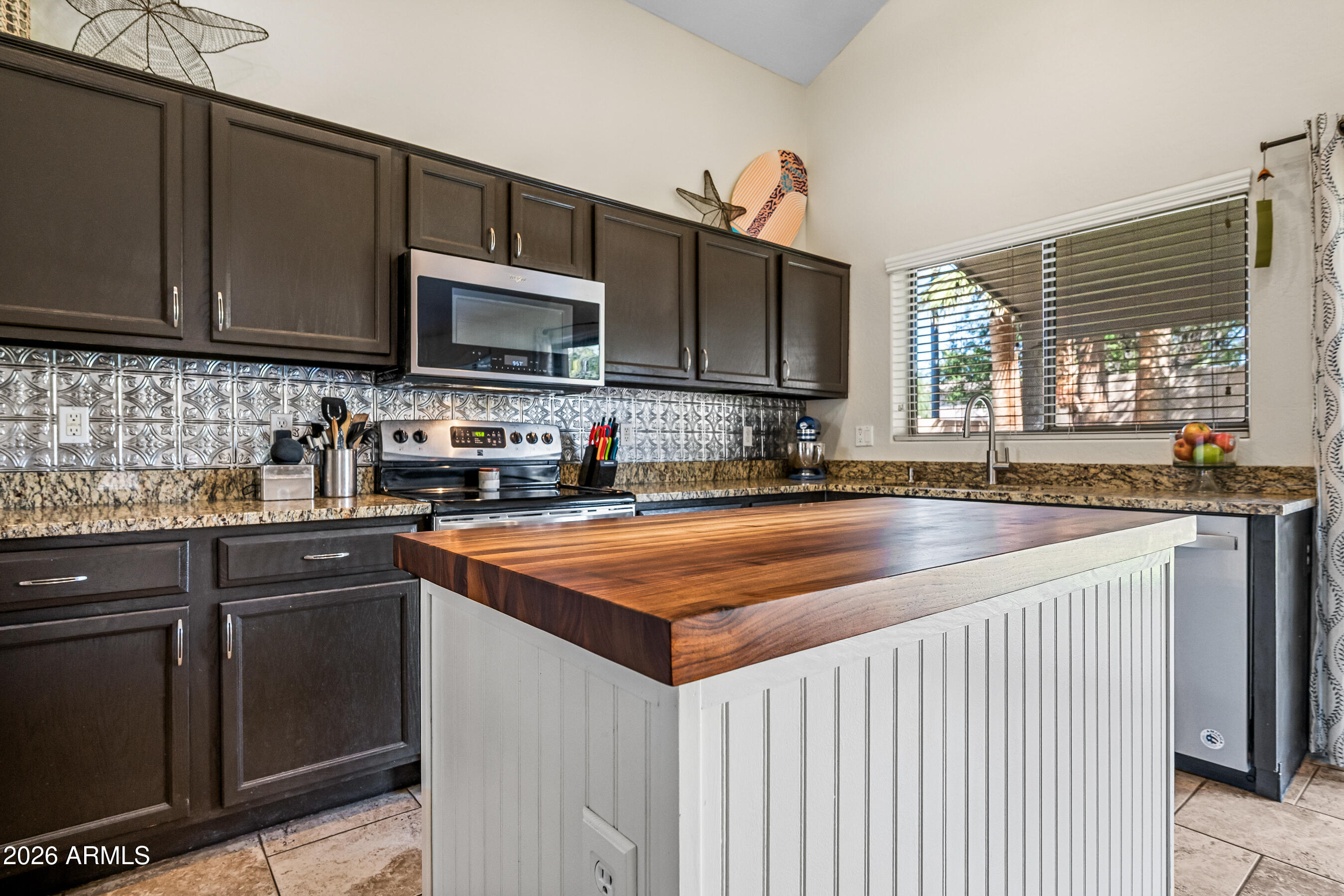 12734 West Cheery Lynn Road Avondale, AZ 85392 - Photo 23 of 54 a kitchen with stainless steel appliances granite countertop a sink stove and microwave