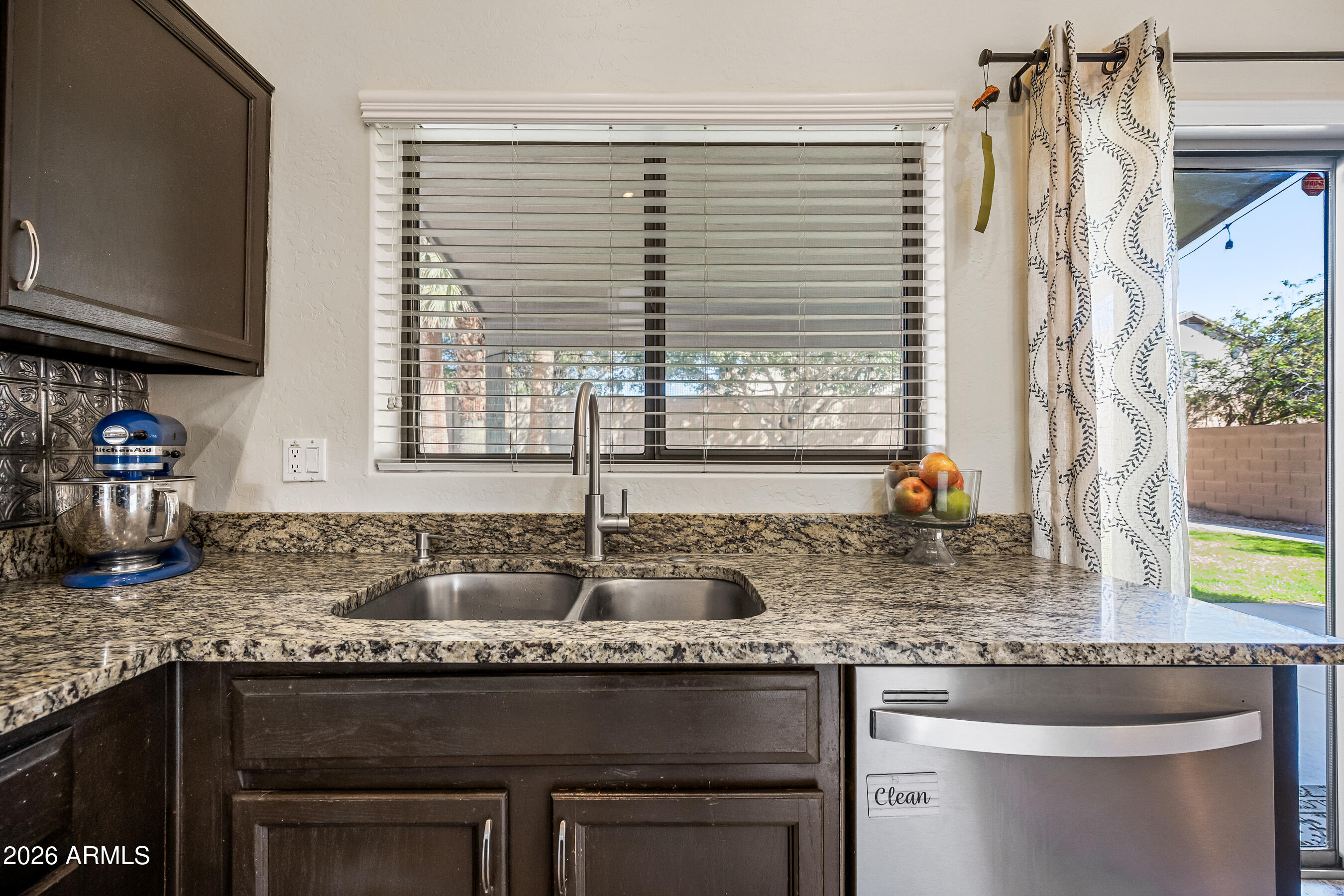 12734 West Cheery Lynn Road Avondale, AZ 85392 - Photo 26 of 54 a kitchen with granite countertop a sink and a stove