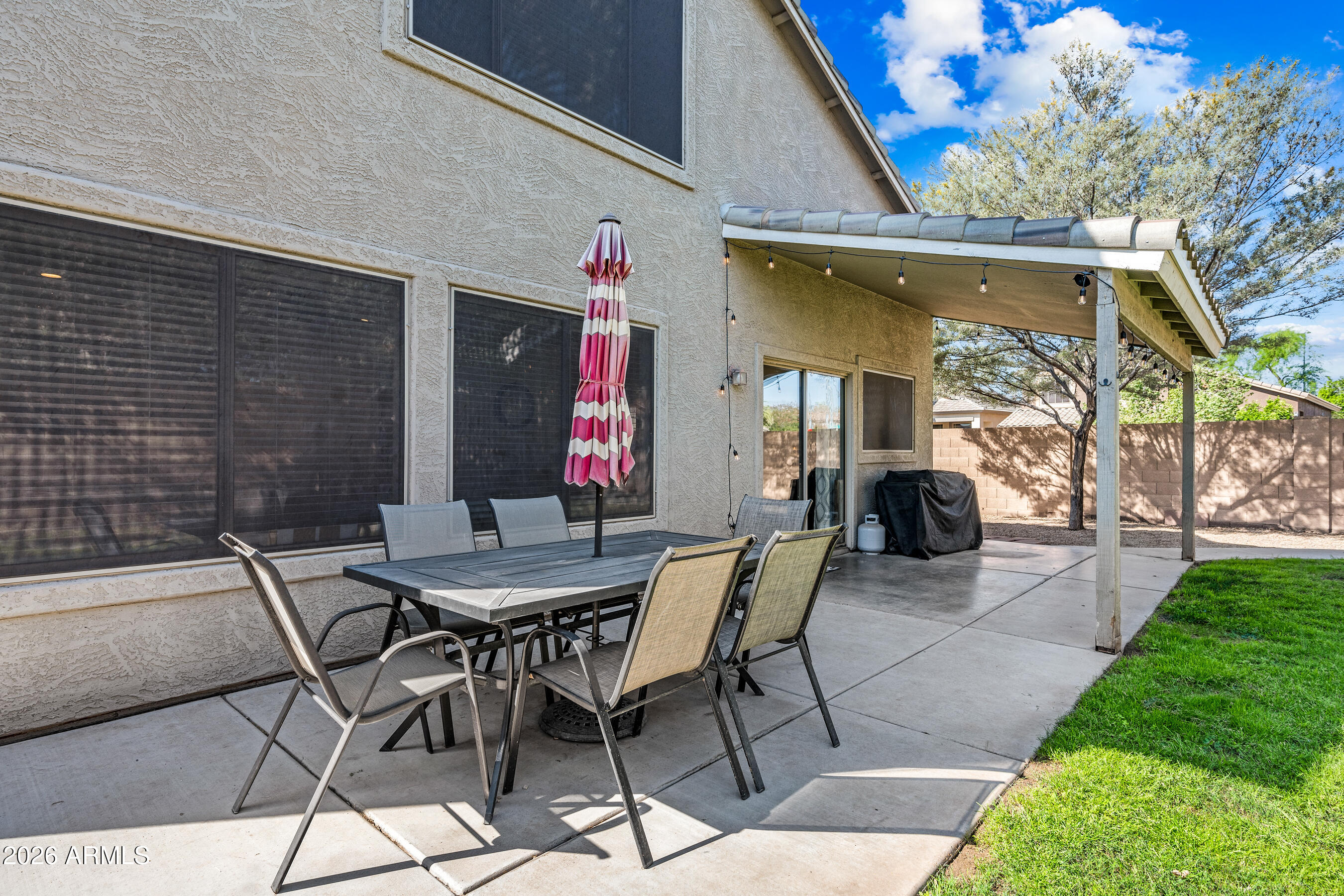 12734 West Cheery Lynn Road Avondale, AZ 85392 - Photo 29 of 54 a view of a patio with a table and chairs and potted plants