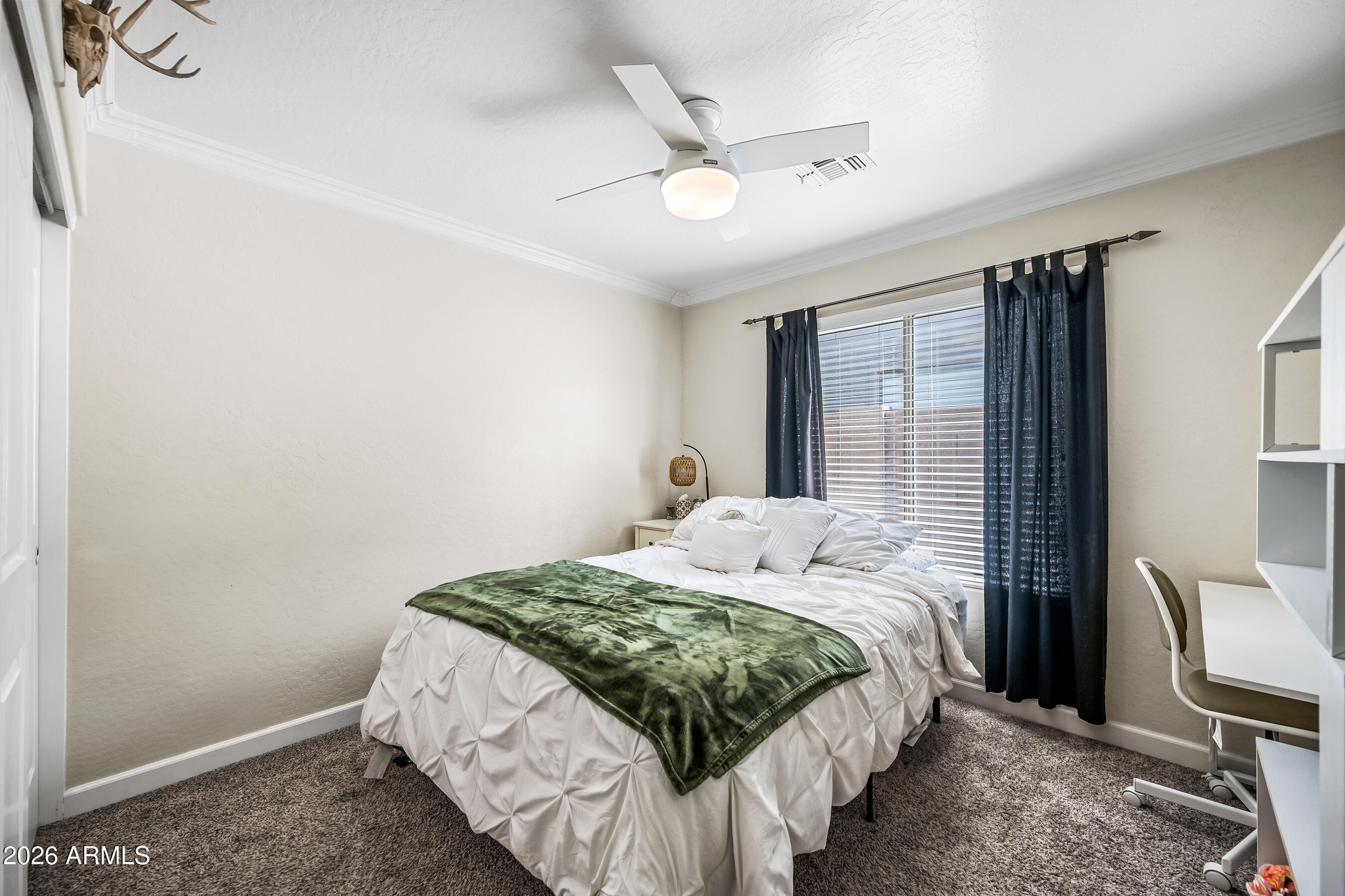 12734 West Cheery Lynn Road Avondale, AZ 85392 - Photo 32 of 54 a bedroom with a bed and a cabinets
