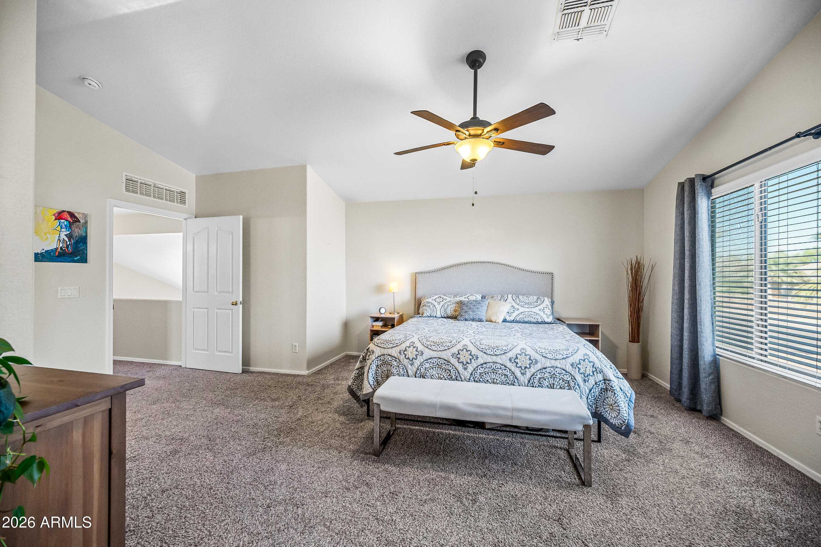 12734 West Cheery Lynn Road Avondale, AZ 85392 - Photo 40 of 54 a bedroom with a bed and a chandelier