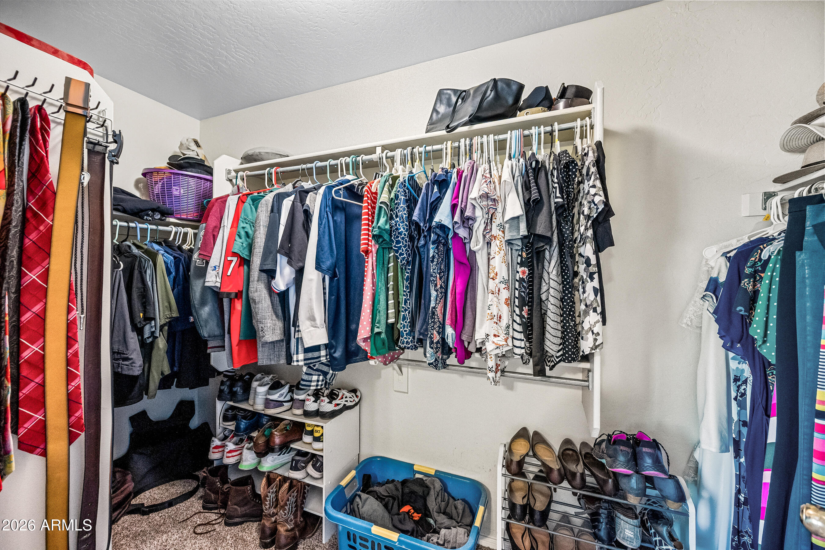 12734 West Cheery Lynn Road Avondale, AZ 85392 - Photo 46 of 54 a view of walk in closet with clothes