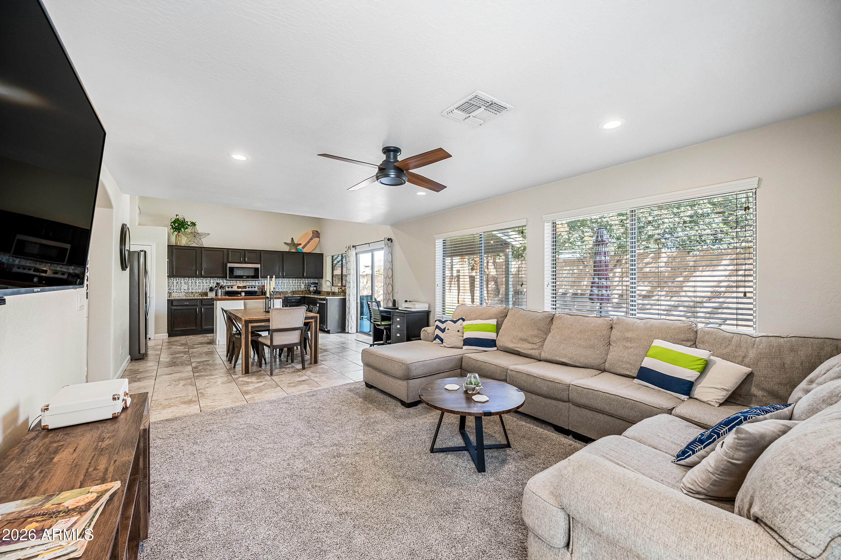 12734 West Cheery Lynn Road Avondale, AZ 85392 - Photo 3 of 54 a living room with furniture and a flat screen tv