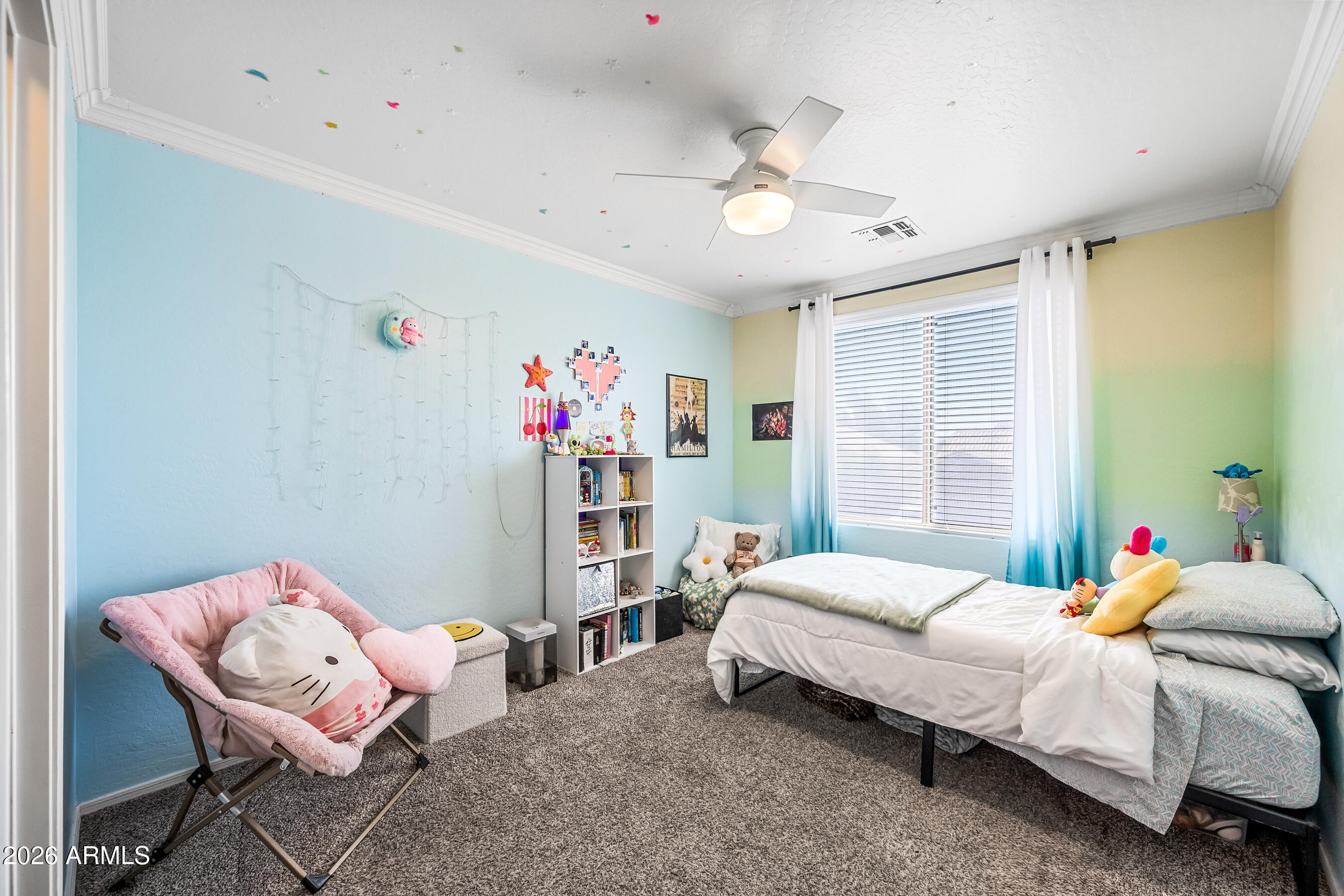 12734 West Cheery Lynn Road Avondale, AZ 85392 - Photo 49 of 54 a bedroom with a bed and a chandelier