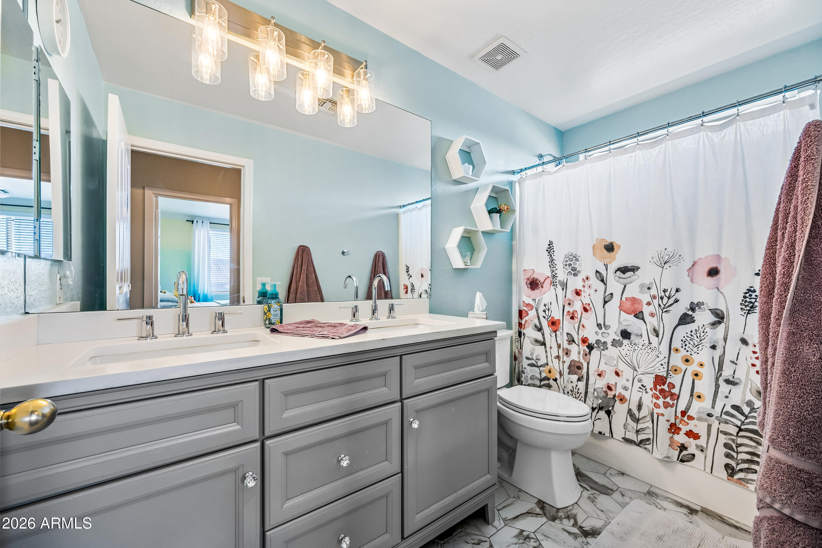 12734 West Cheery Lynn Road Avondale, AZ 85392 - Photo 50 of 54 a bathroom with a double vanity sink toilet and shower