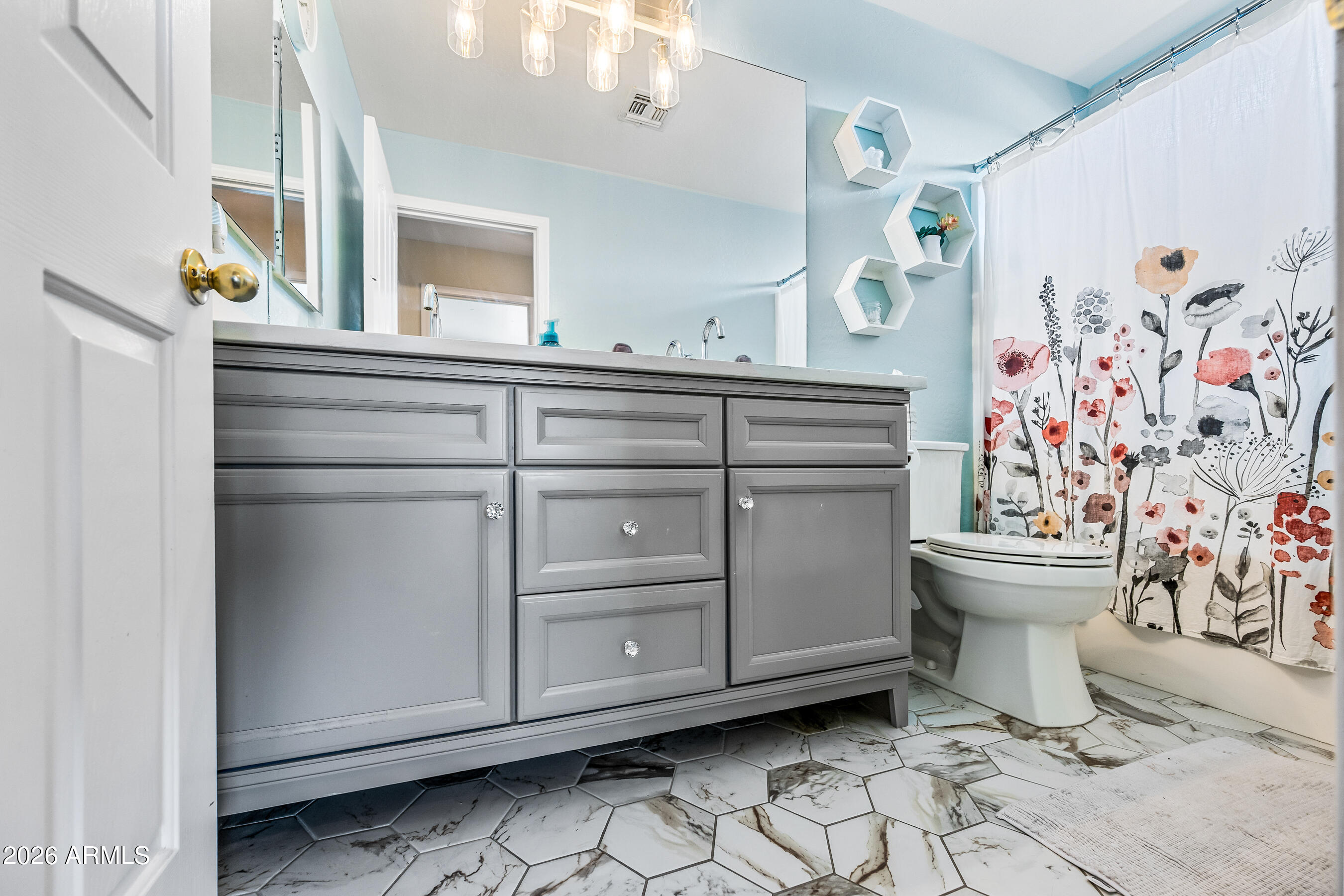 12734 West Cheery Lynn Road Avondale, AZ 85392 - Photo 51 of 54 a bathroom with a sink toilet and mirror