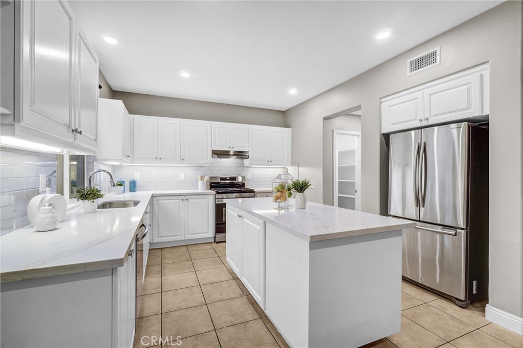 45 Avondale Irvine, CA 92602 - Photo 11 of 28 a kitchen with white cabinets and refrigerator