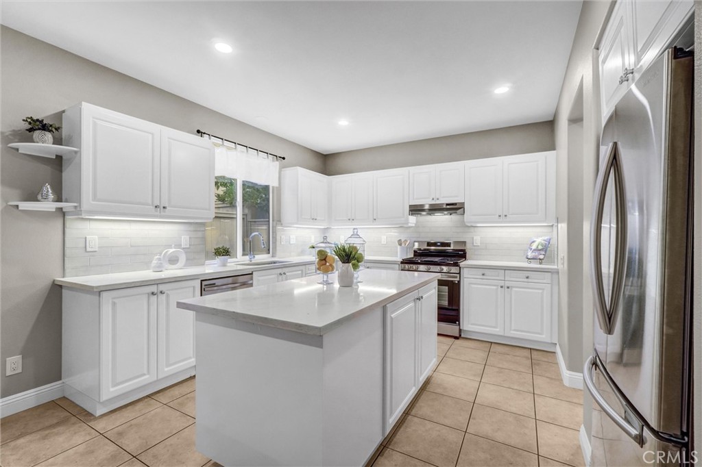 45 Avondale Irvine, CA 92602 - Photo 10 of 28 a kitchen with white cabinets stainless steel appliances and a sink