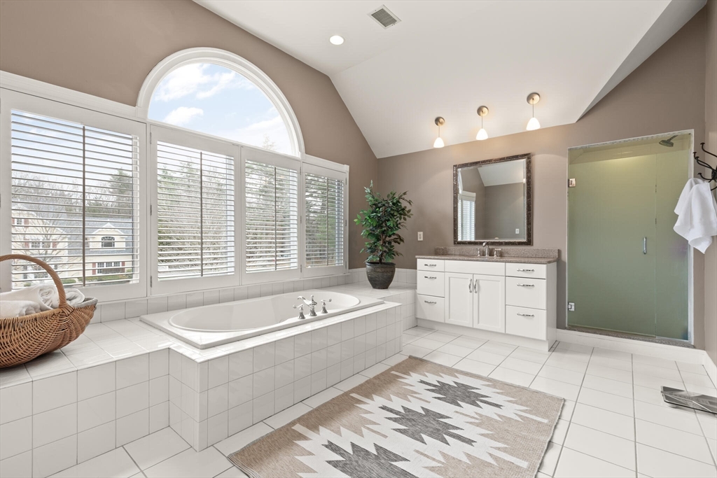 33 Bulkley Road Sudbury, MA 01776 - Photo 25 of 42 a spacious bathroom with a tub sink and mirror