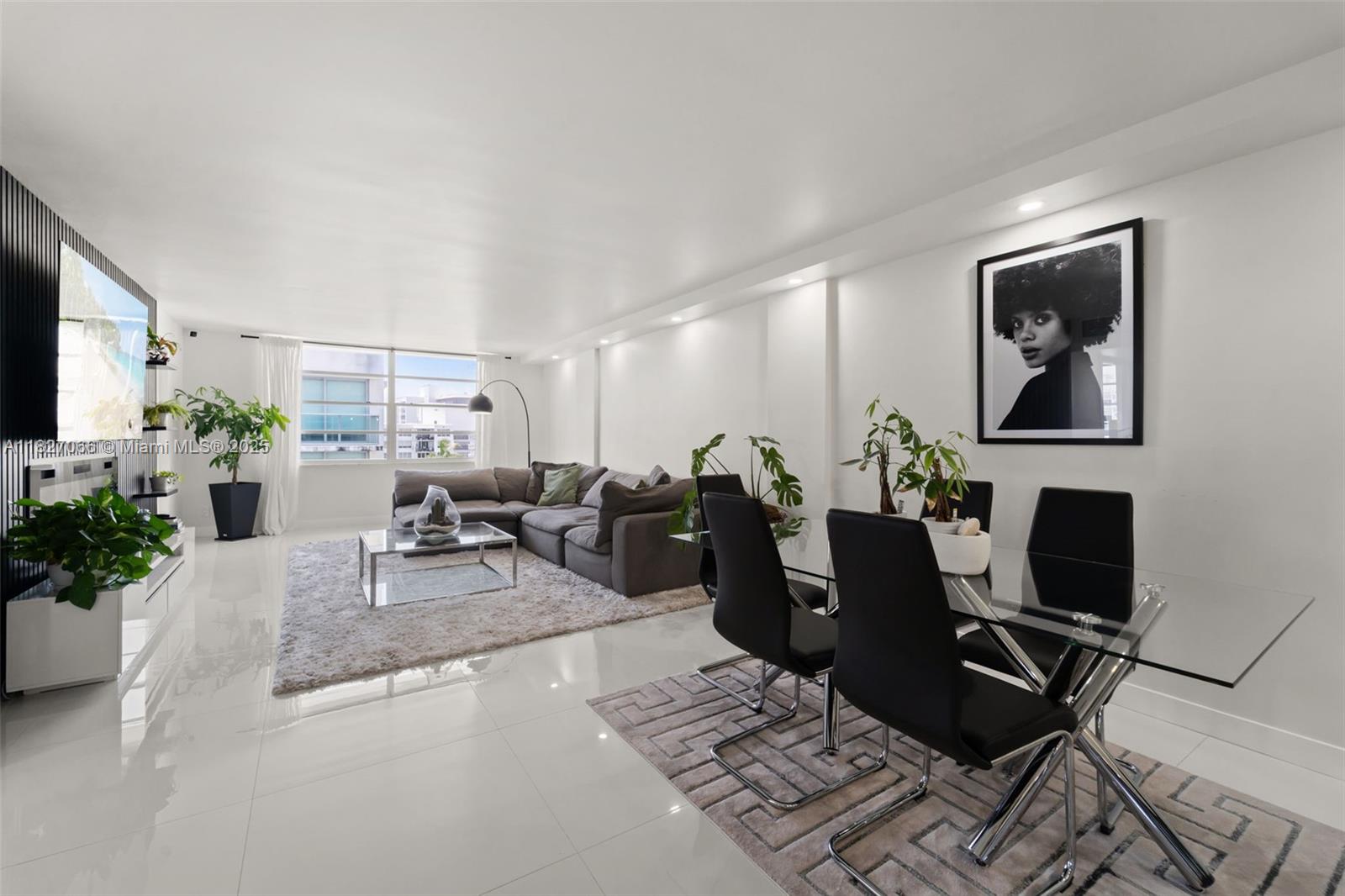 a living room with furniture a wooden floor and a flat screen tv
