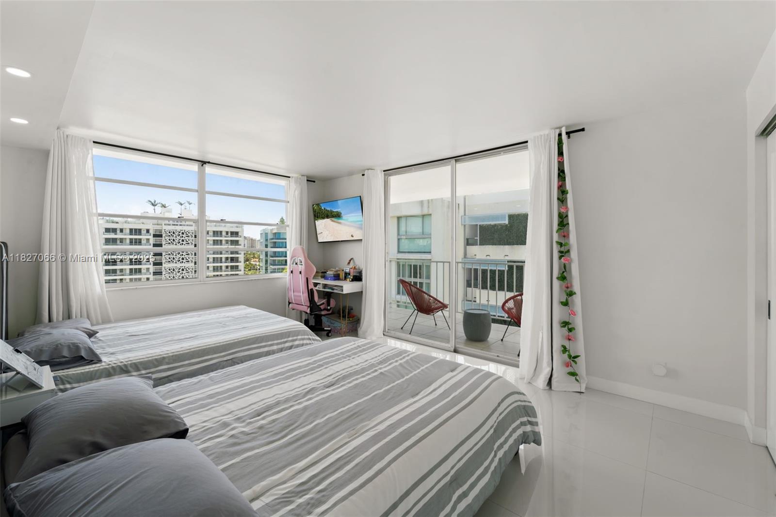 1050 93rd Street, Unit 7H Bay Harbor Islands, FL 33154 - Photo 11 of 18 a bedroom with a bed and a large window