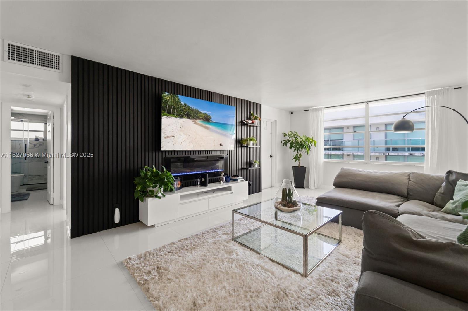 1050 93rd Street, Unit 7H Bay Harbor Islands, FL 33154 - Photo 13 of 18 a living room with furniture and a flat screen tv