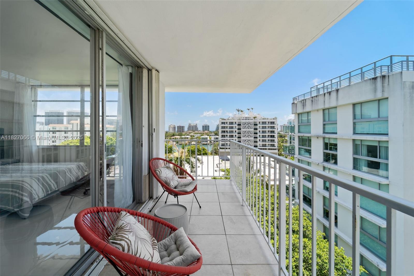 1050 93rd Street, Unit 7H Bay Harbor Islands, FL 33154 - Photo 14 of 18 a balcony with chairs and city view