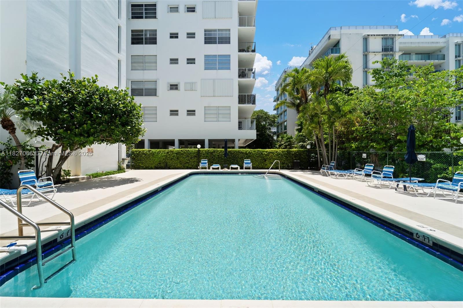 1050 93rd Street, Unit 7H Bay Harbor Islands, FL 33154 - Photo 16 of 18 a swimming pool with outdoor seating and yard