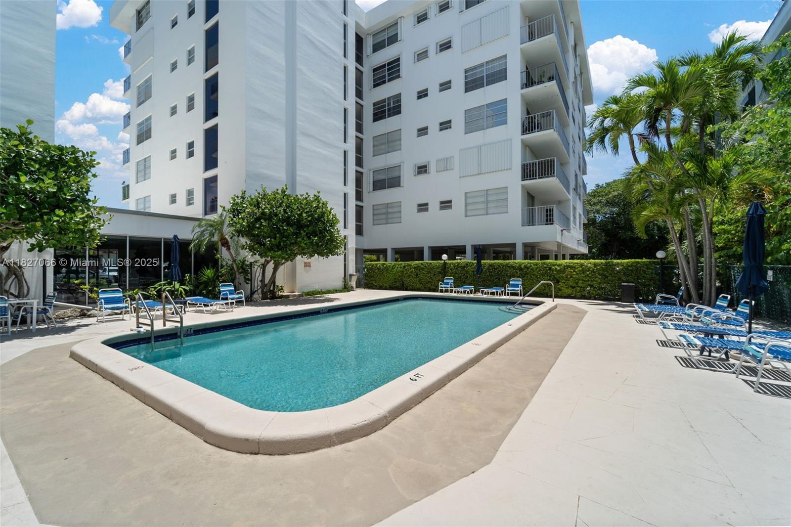 1050 93rd Street, Unit 7H Bay Harbor Islands, FL 33154 - Photo 18 of 18 a view of a swimming pool with a lounge chairs