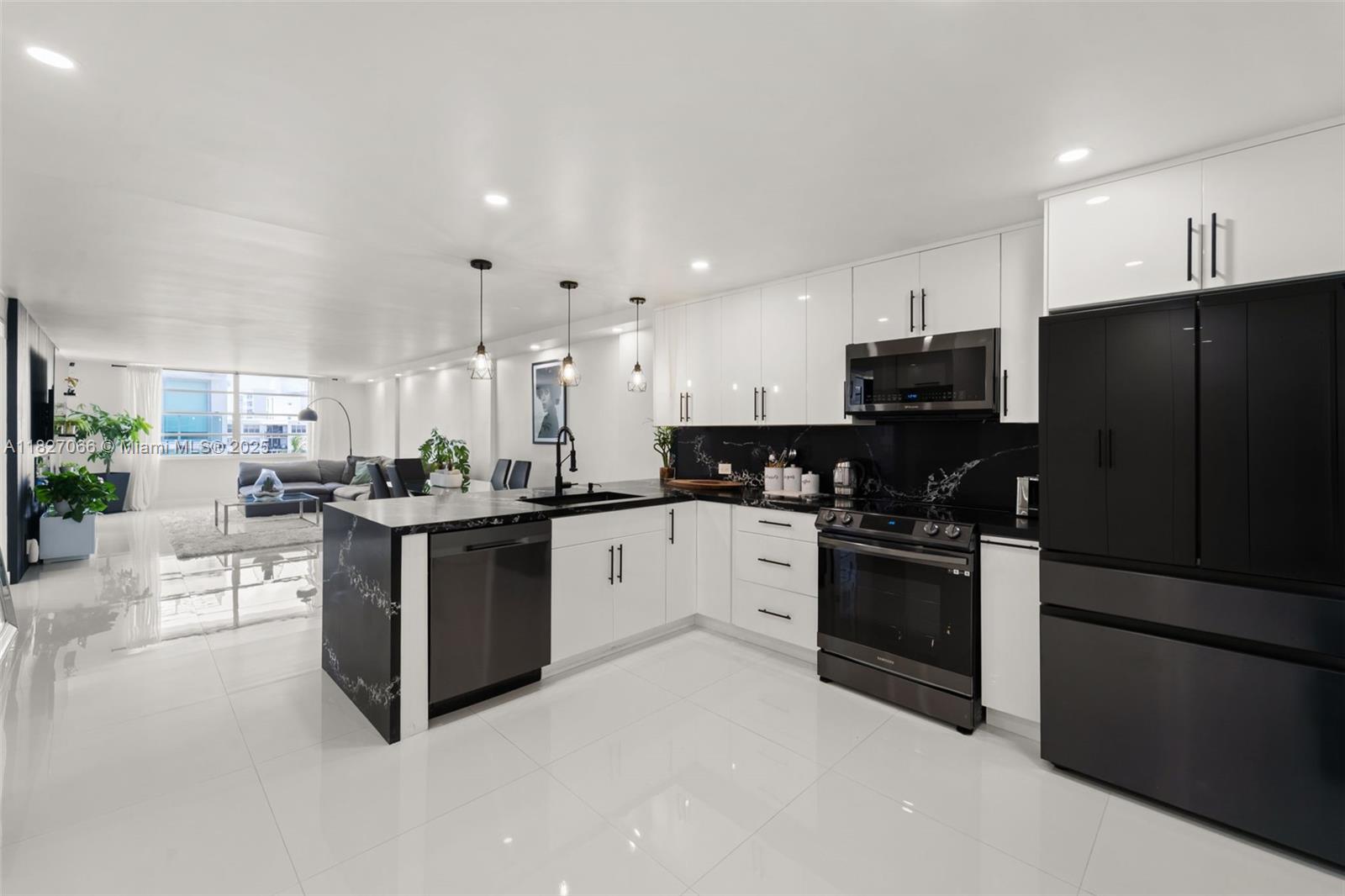 1050 93rd Street, Unit 7H Bay Harbor Islands, FL 33154 - Photo 3 of 18 a large kitchen with stainless steel appliances and a refrigerator