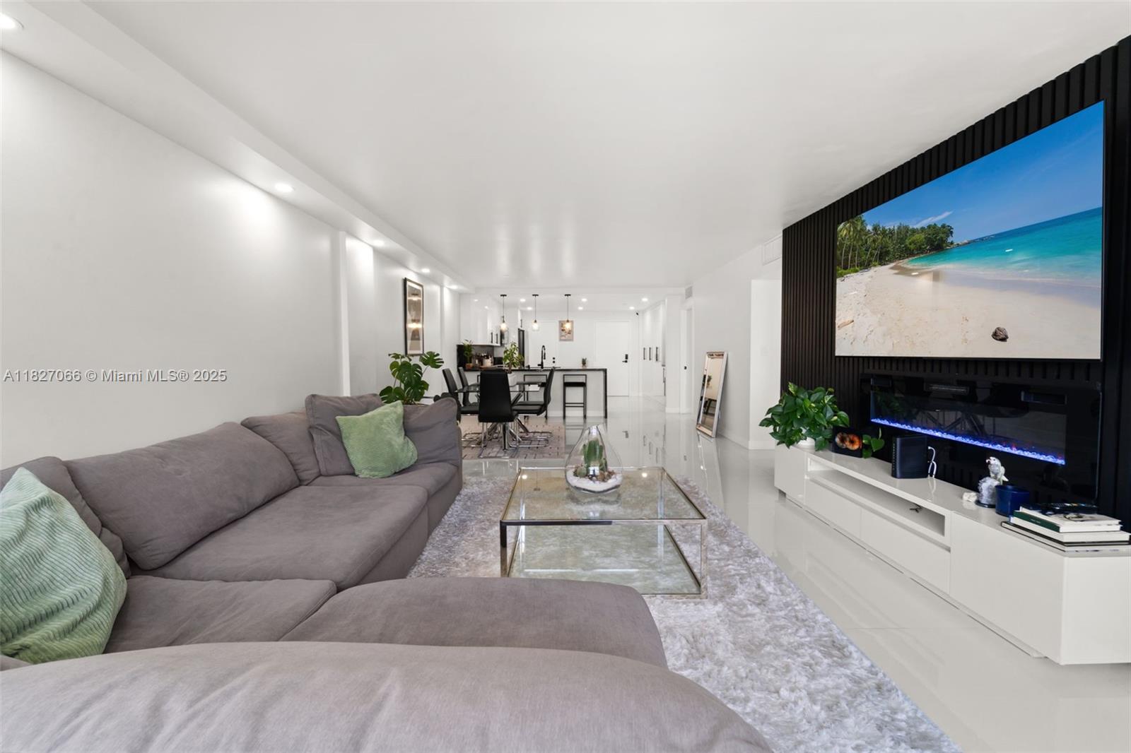 1050 93rd Street, Unit 7H Bay Harbor Islands, FL 33154 - Photo 5 of 18 a living room with furniture and a flat screen tv