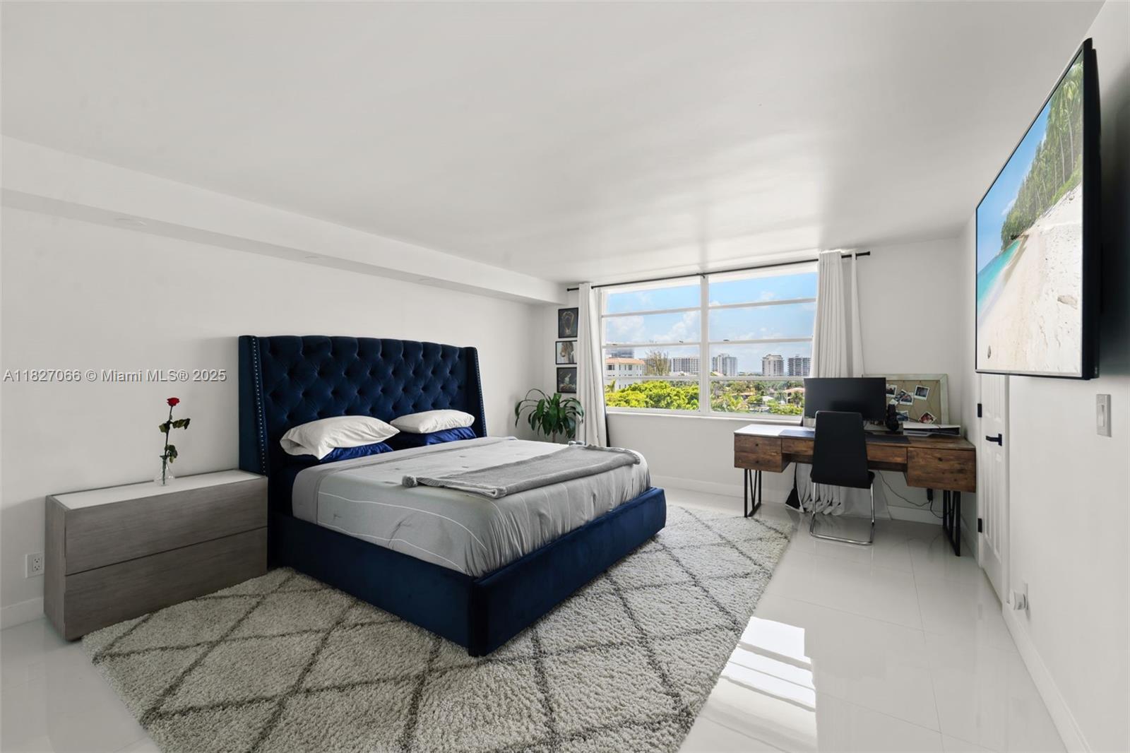 1050 93rd Street, Unit 7H Bay Harbor Islands, FL 33154 - Photo 6 of 18 a bedroom with a bed and large window