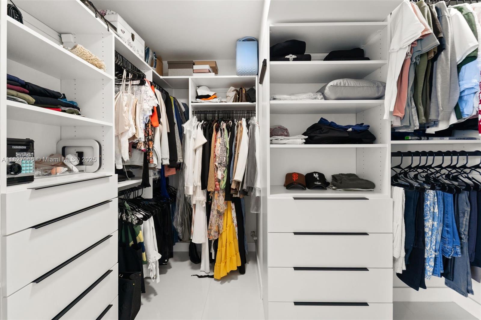 1050 93rd Street, Unit 7H Bay Harbor Islands, FL 33154 - Photo 9 of 18 a view of walk in closet with clothes and shoes