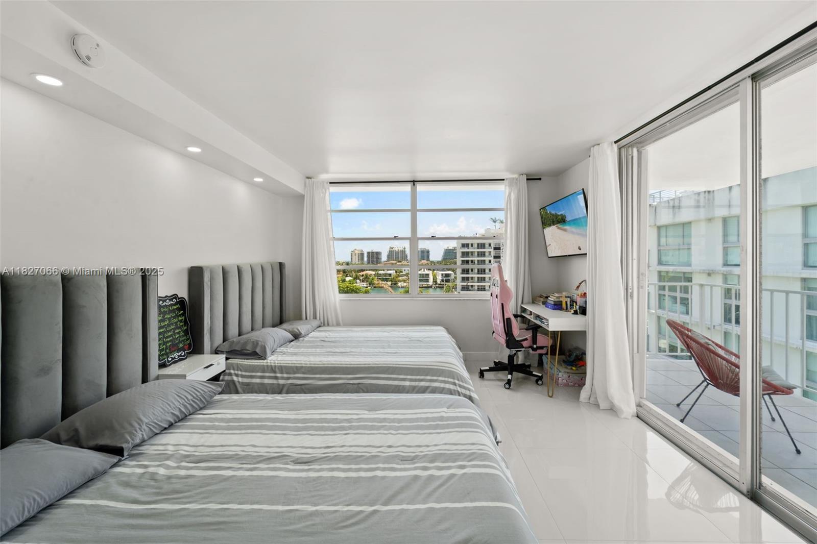 1050 93rd Street, Unit 7H Bay Harbor Islands, FL 33154 - Photo 10 of 18 a bedroom with a bed and a large window