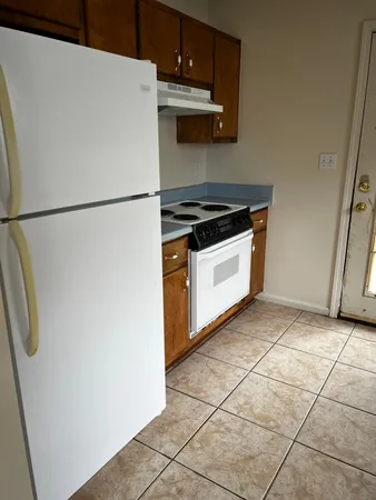 a kitchen with a stove top oven and cabinets