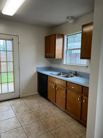 a spacious bathroom with a granite countertop sink and a mirror