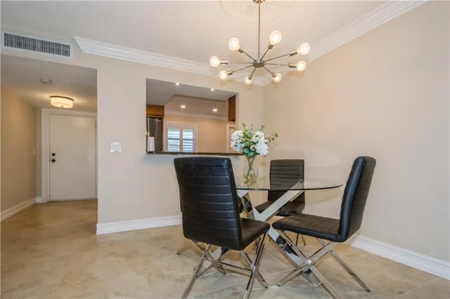 a dining room with furniture and chandelier