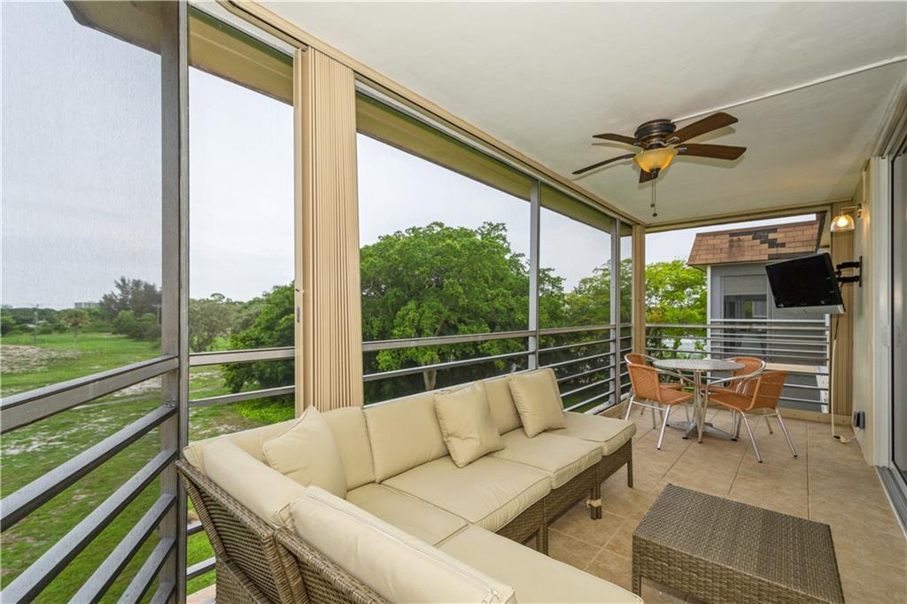 6000 Northwest 2nd Avenue, Unit 437 Boca Raton, FL 33487 - Photo 20 of 22 a balcony with furniture and a floor to ceiling window