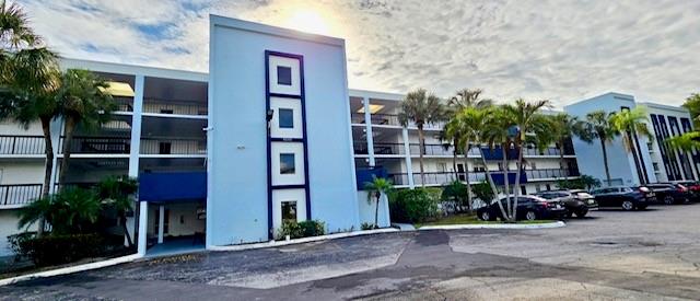 6000 Northwest 2nd Avenue, Unit 437 Boca Raton, FL 33487 - Photo 2 of 22 a couple of table and chairs in front of building