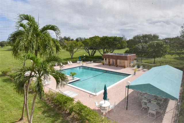 a view of a swimming pool with a yard