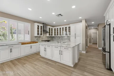 a large kitchen with stainless steel appliances granite countertop a large center island and a sink