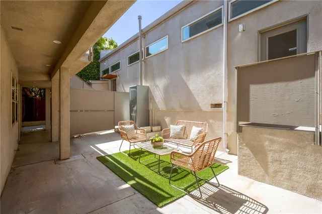 a kitchen with stainless steel appliances granite countertop a refrigerator a stove and a dining table with wooden floor