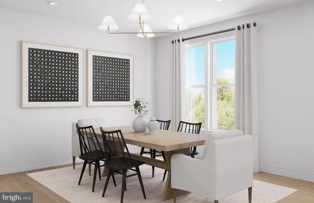 a kitchen with stainless steel appliances granite countertop a dining table chairs and a refrigerator