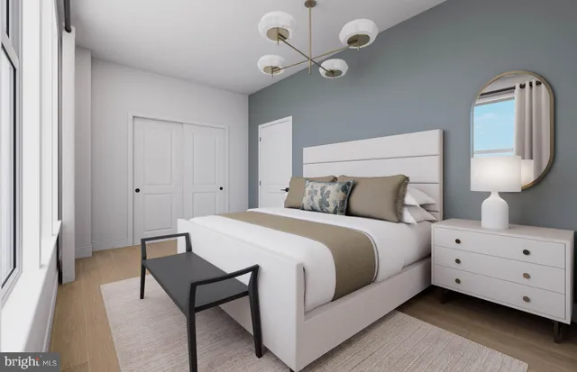 a spacious bedroom with a bed and a chandelier