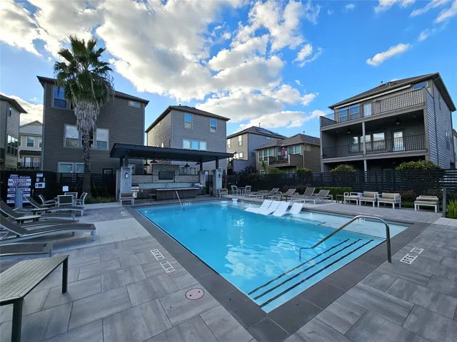 a view of a house with swimming pool and sitting area