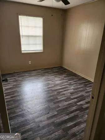 a view of a closet area with wooden floor