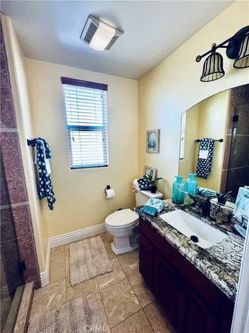 a bathroom with a glass door shower and a sink