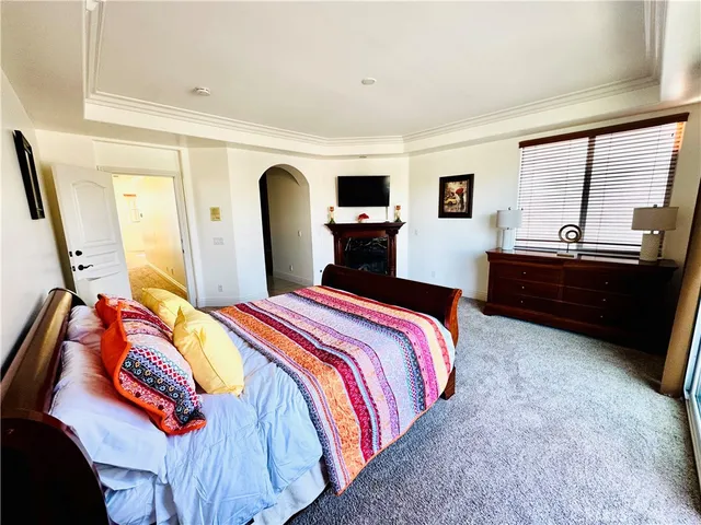 a large bathroom with a tub sink and mirror