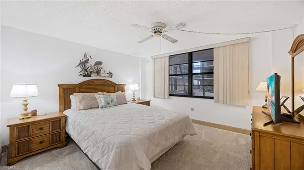 a bedroom with a bed and a dresser in it