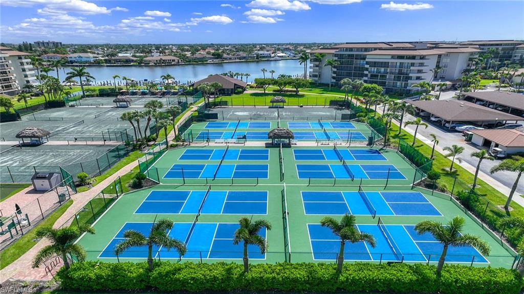 601 Seaview Court, Unit C106 Marco Island, FL 34145 - Photo 21 of 42 Drone / aerial view of a nearby body of water and apartment complex
