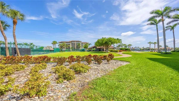 a view of a large pool with a big yard