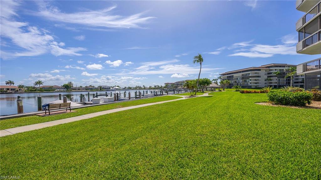 601 Seaview Court, Unit C106 Marco Island, FL 34145 - Photo 40 of 42 View of community with a yard, a water view, and a boat dock