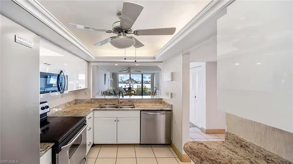 a kitchen with a sink appliances and cabinets