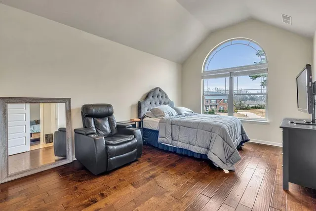 a bedroom with a bed and a couch